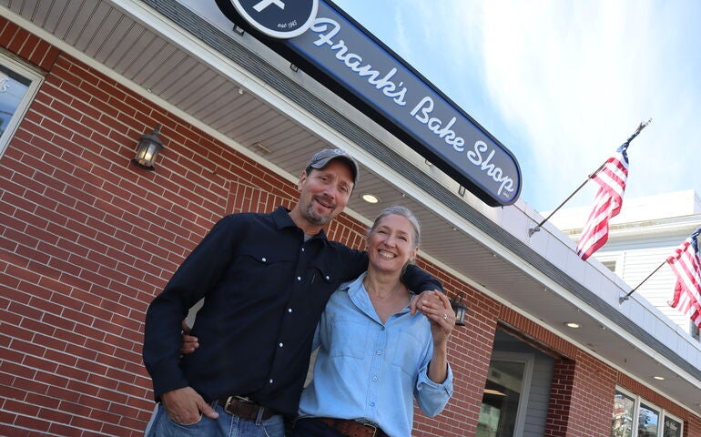 A tilted view of two people in front of a building.