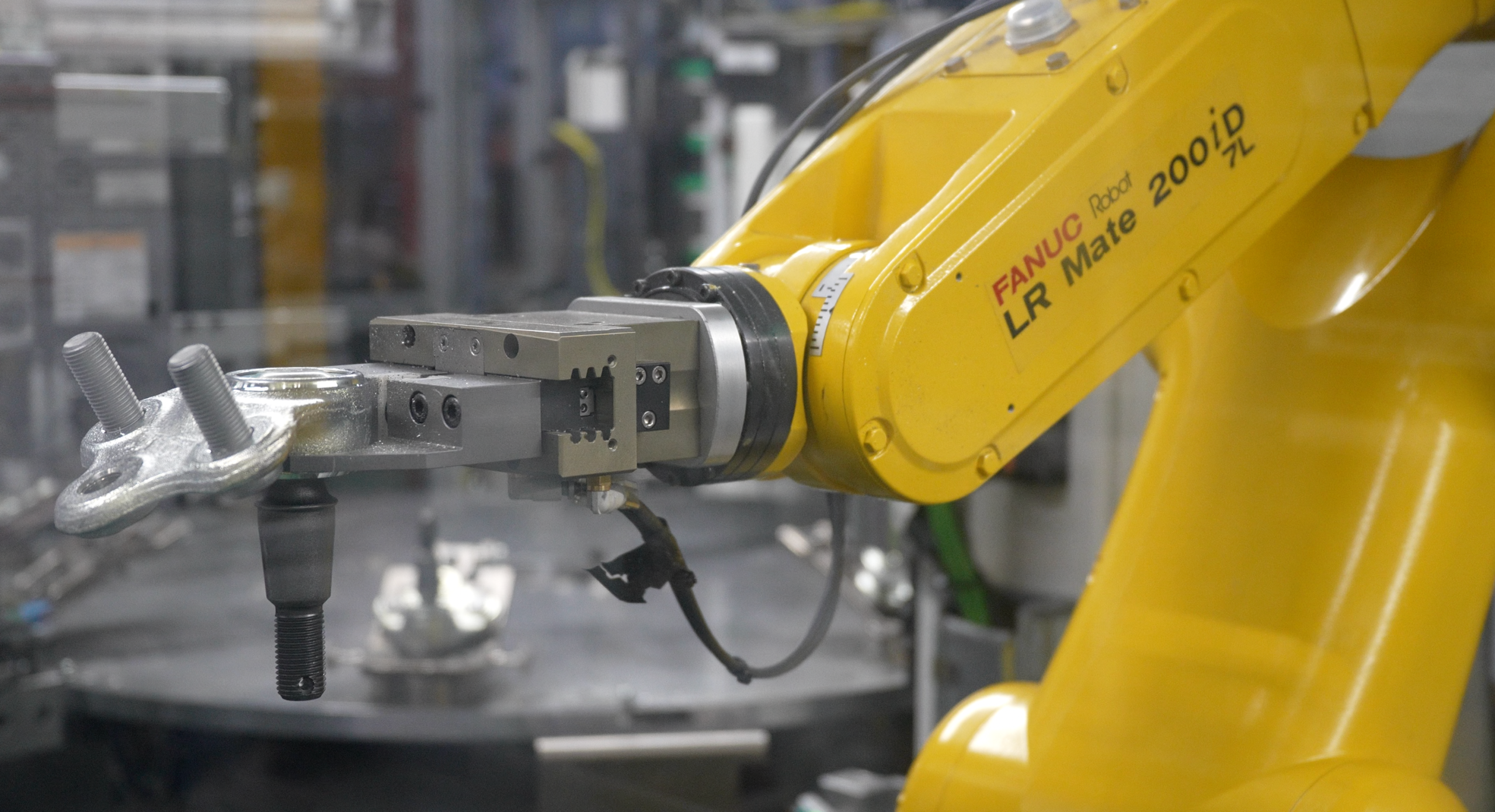 A close-up view of a yellow robot and part.