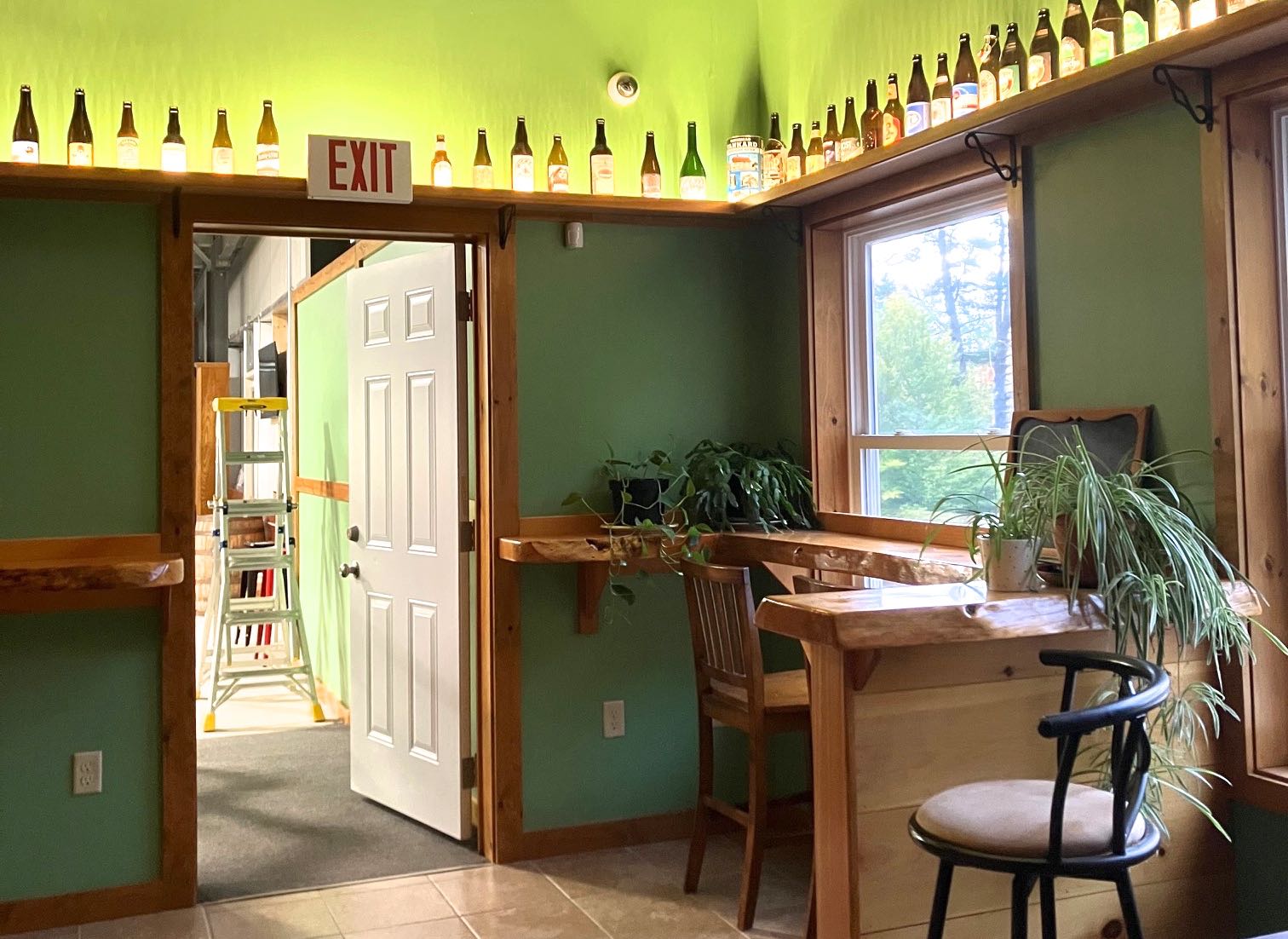 A room has green walls and furnishings.