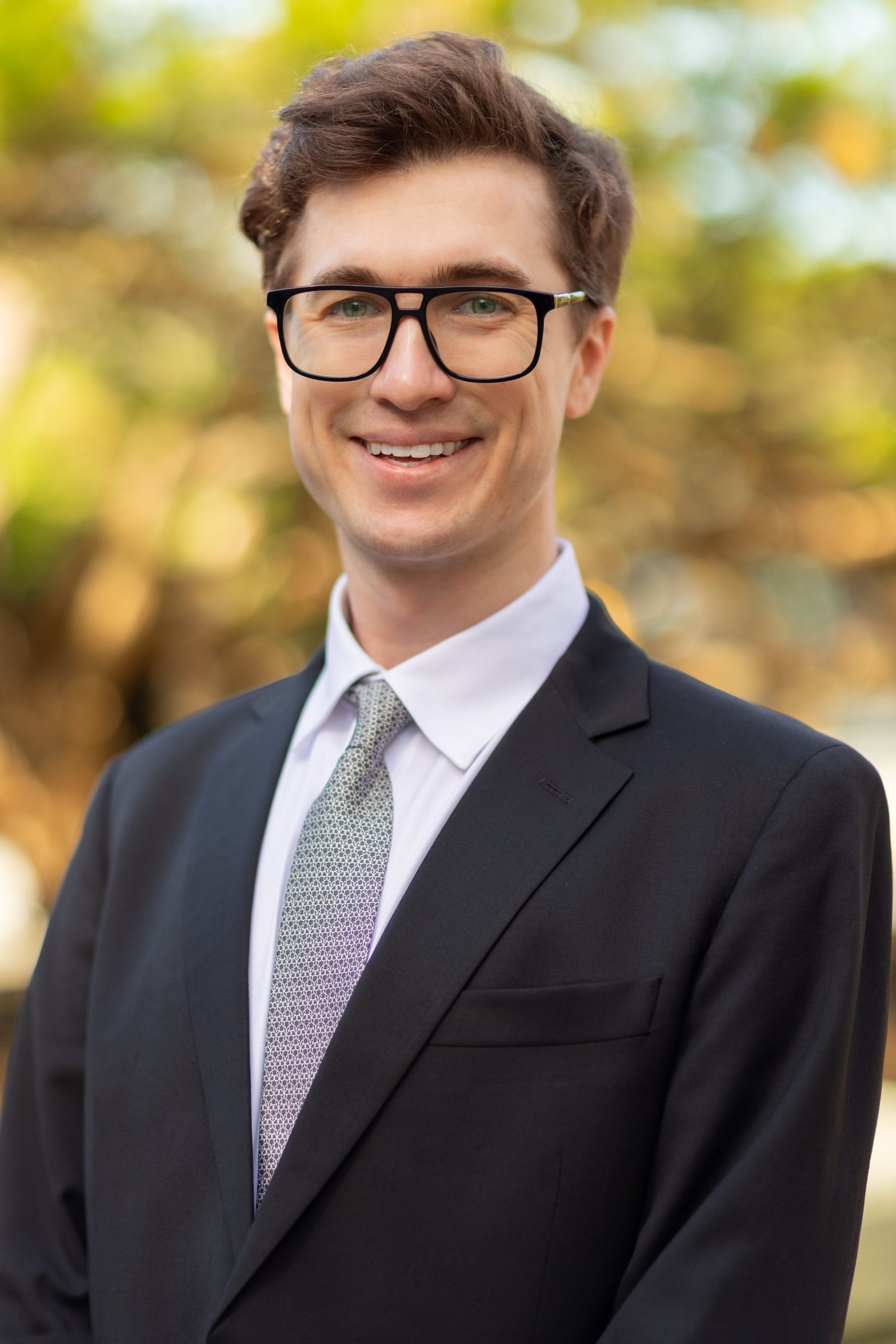 A person poses for a headshot.