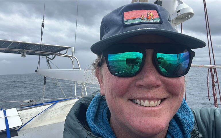A person takes a selfie aboard a boat.