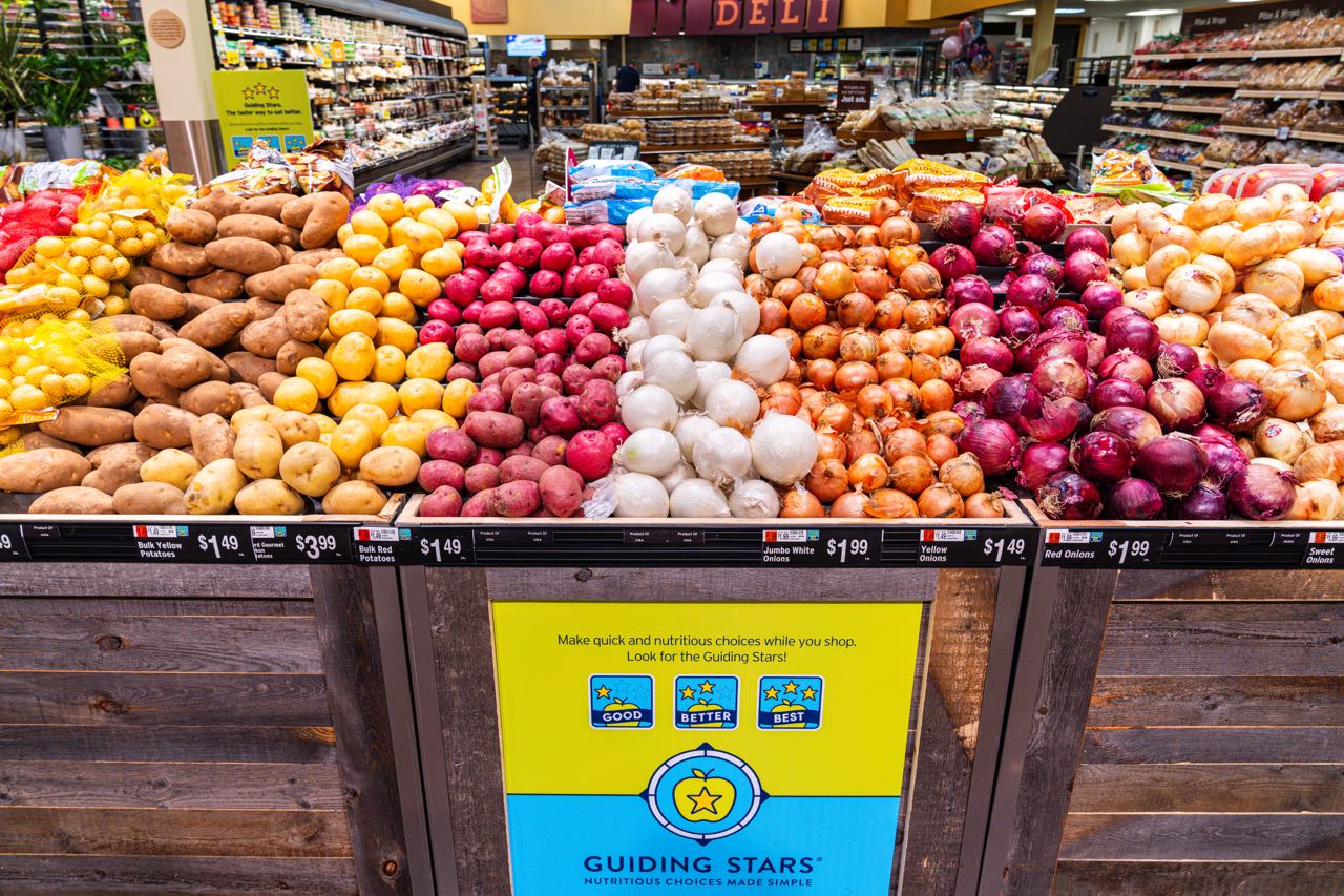 produce piled in wood bins