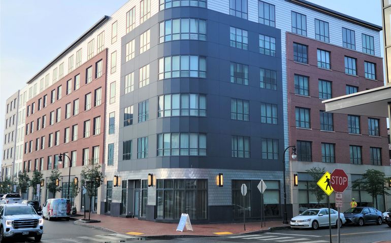 street corner with six-story, brick-facade building