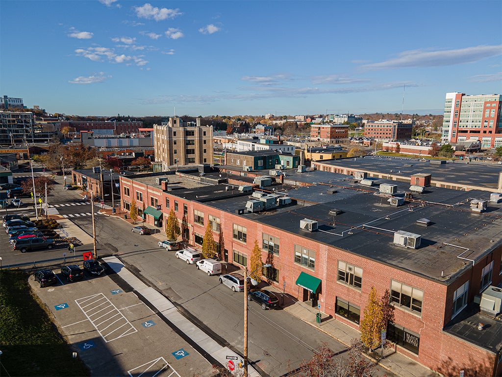 An aerial view shows a long low brick building.
