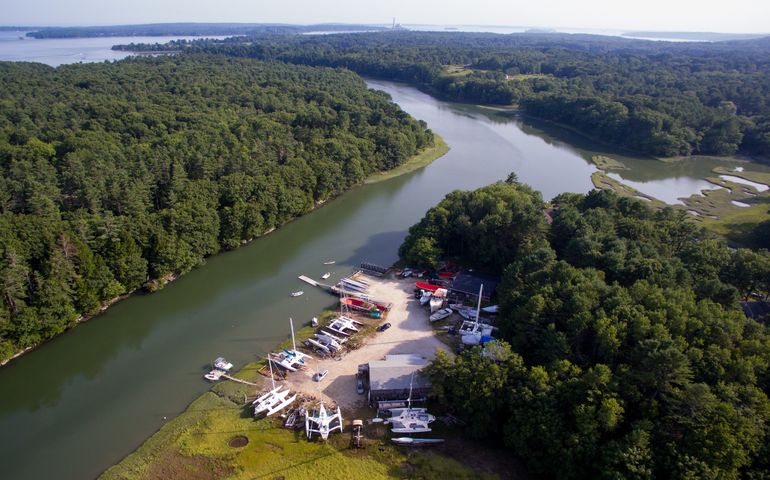 aerial of river, buildings and boats