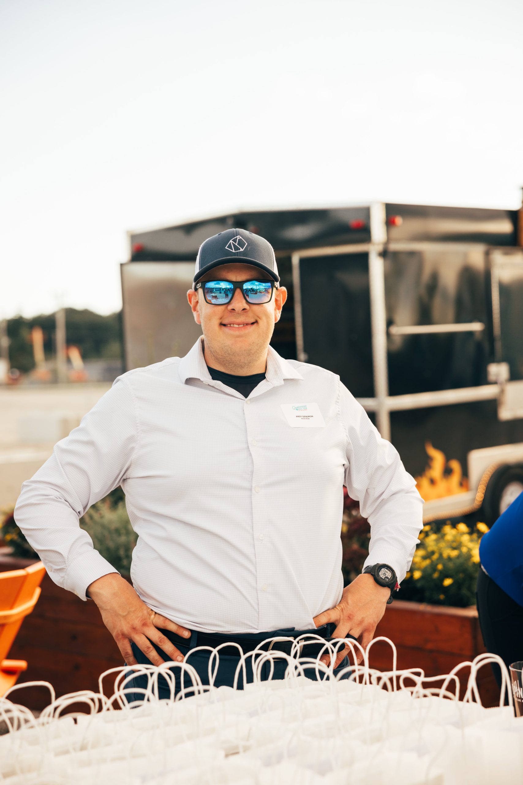 Andy Gendron in a white dress shirt and baseball hat.