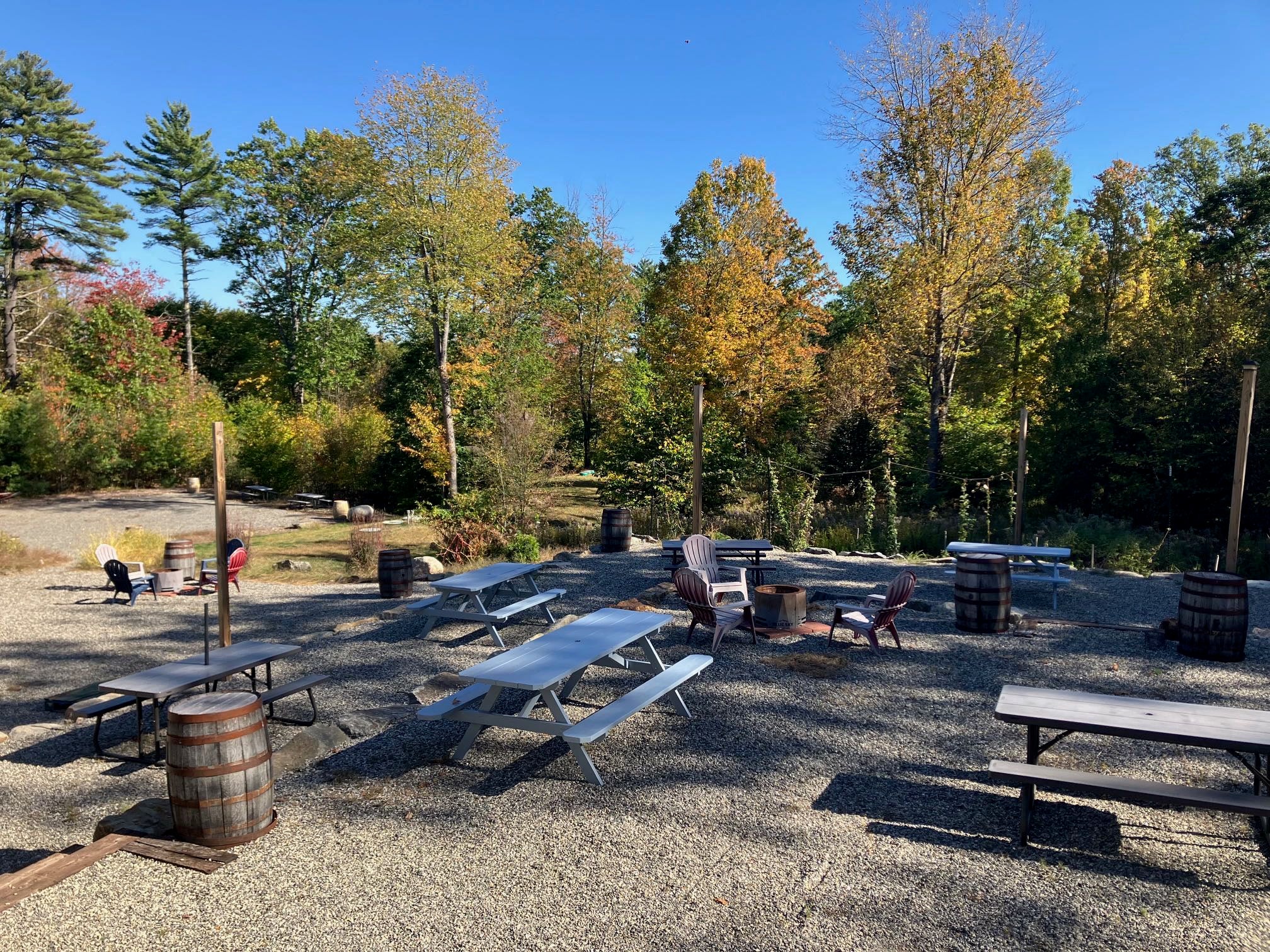 A gravel area outside has picnic benches.