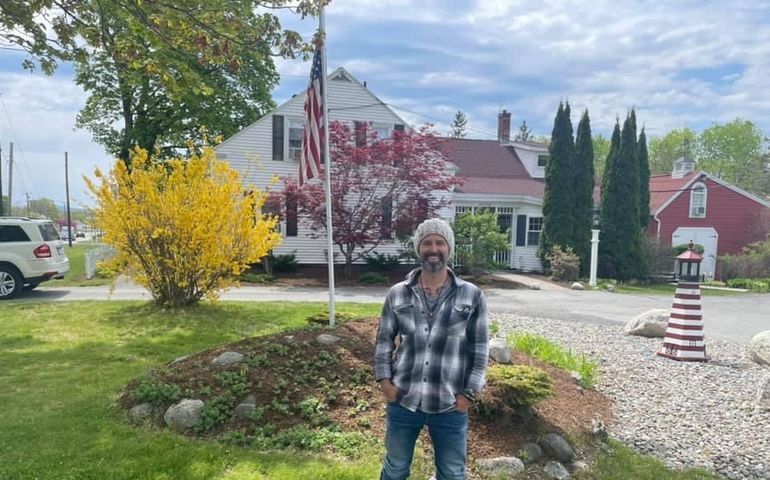 person with flagpole on lawn