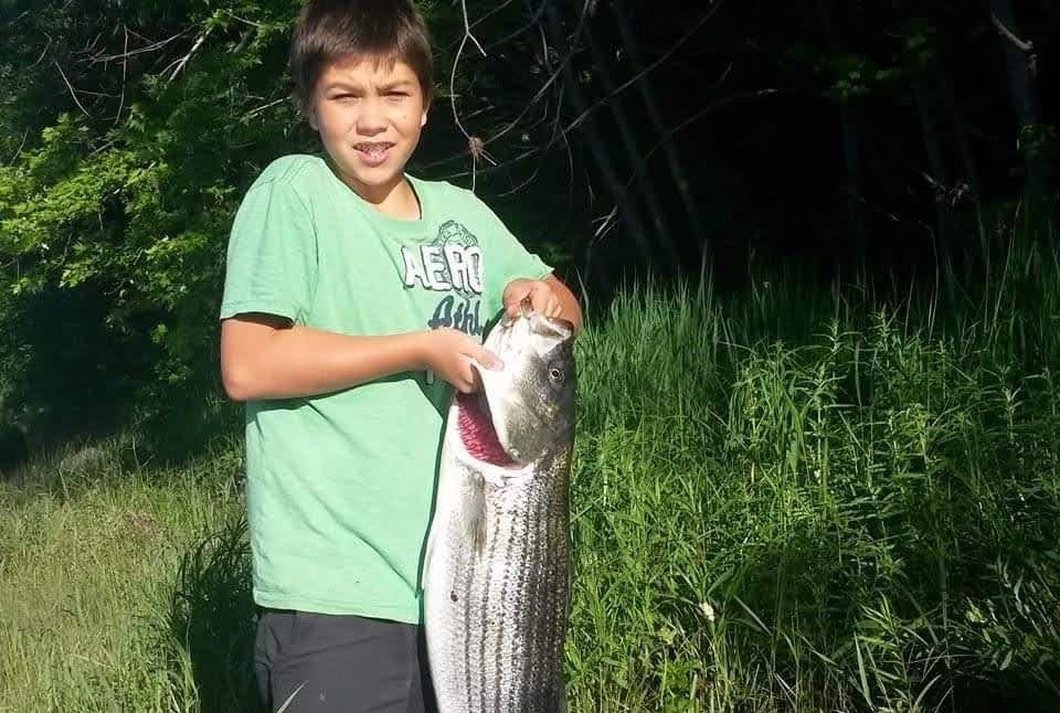 A child holds sa fish.