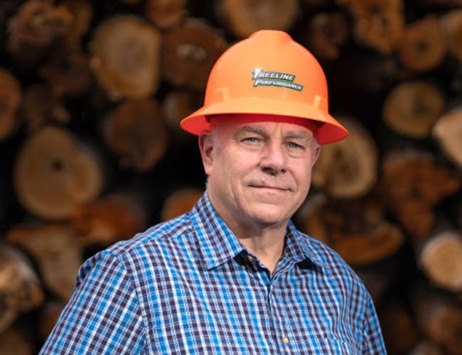 person in plaid shirt and hardhat