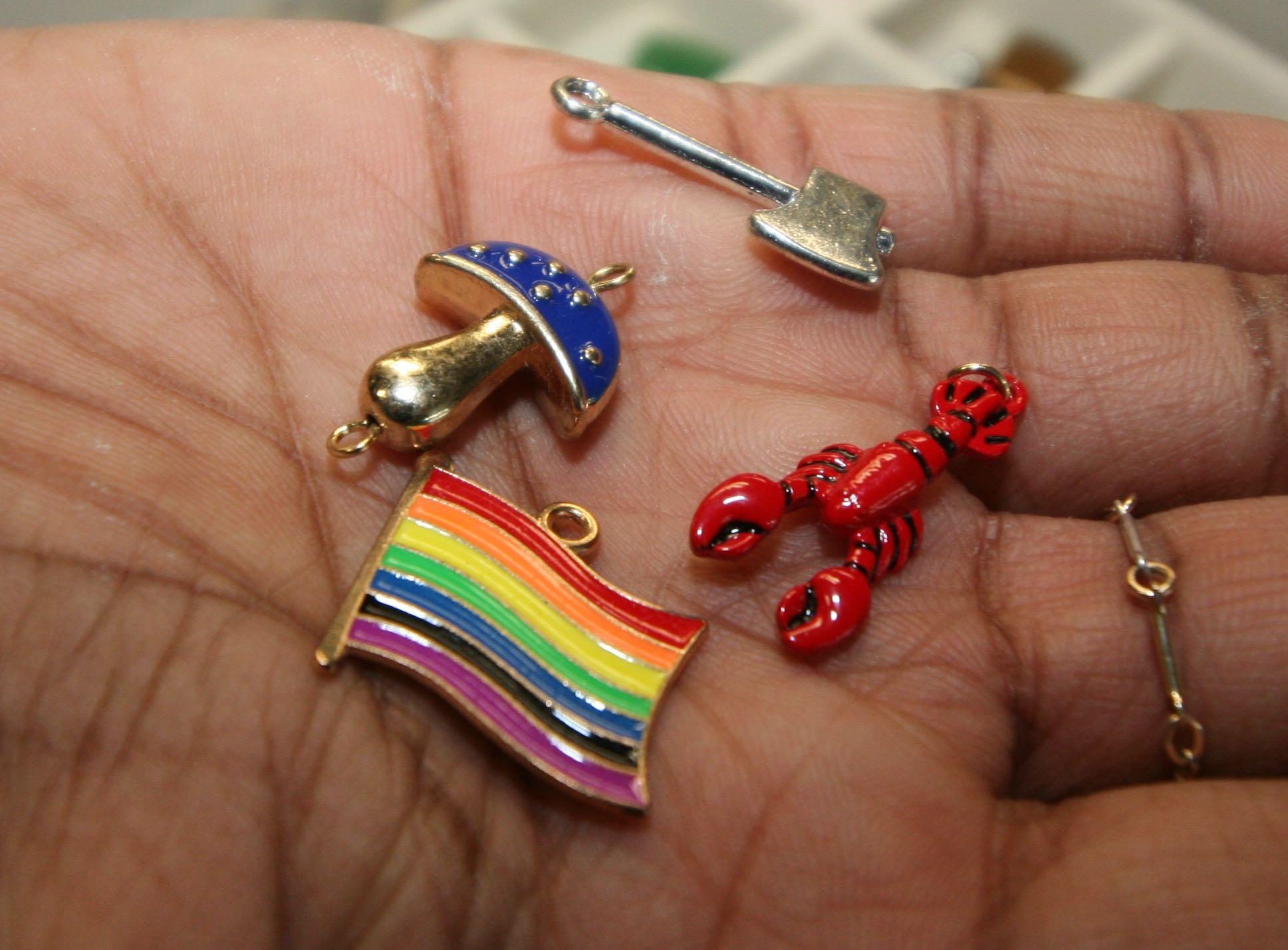 A hand holds colorful small objects.