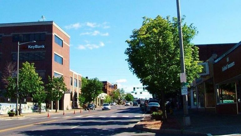 A street lined with buildings and trees.