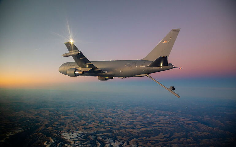 An airplane flies above the clouds.