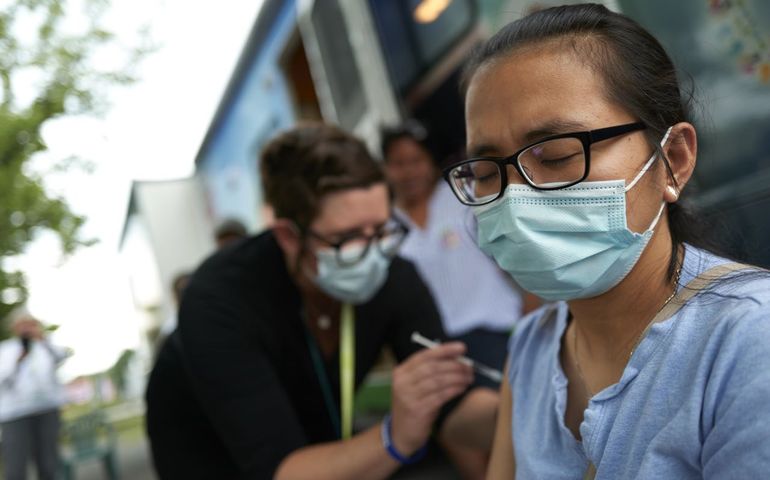 people in masks with vaccine