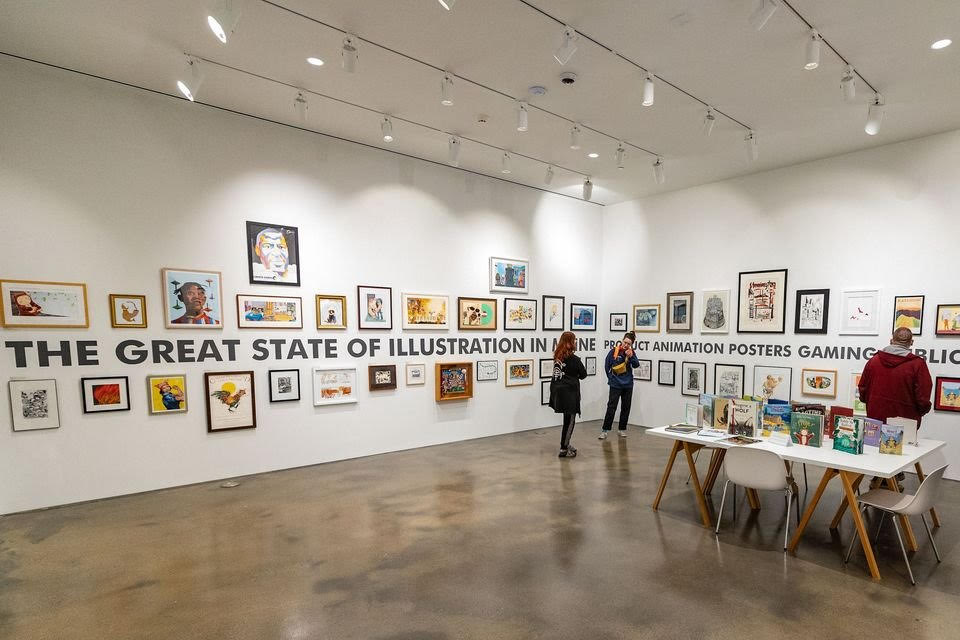 A room has a table and artworks on the walls.