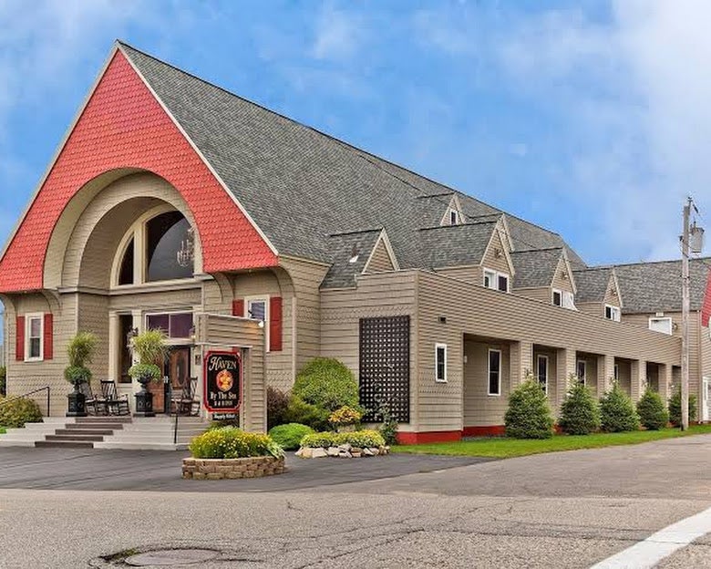 An exterior view of a building with a sharply peaked roof.