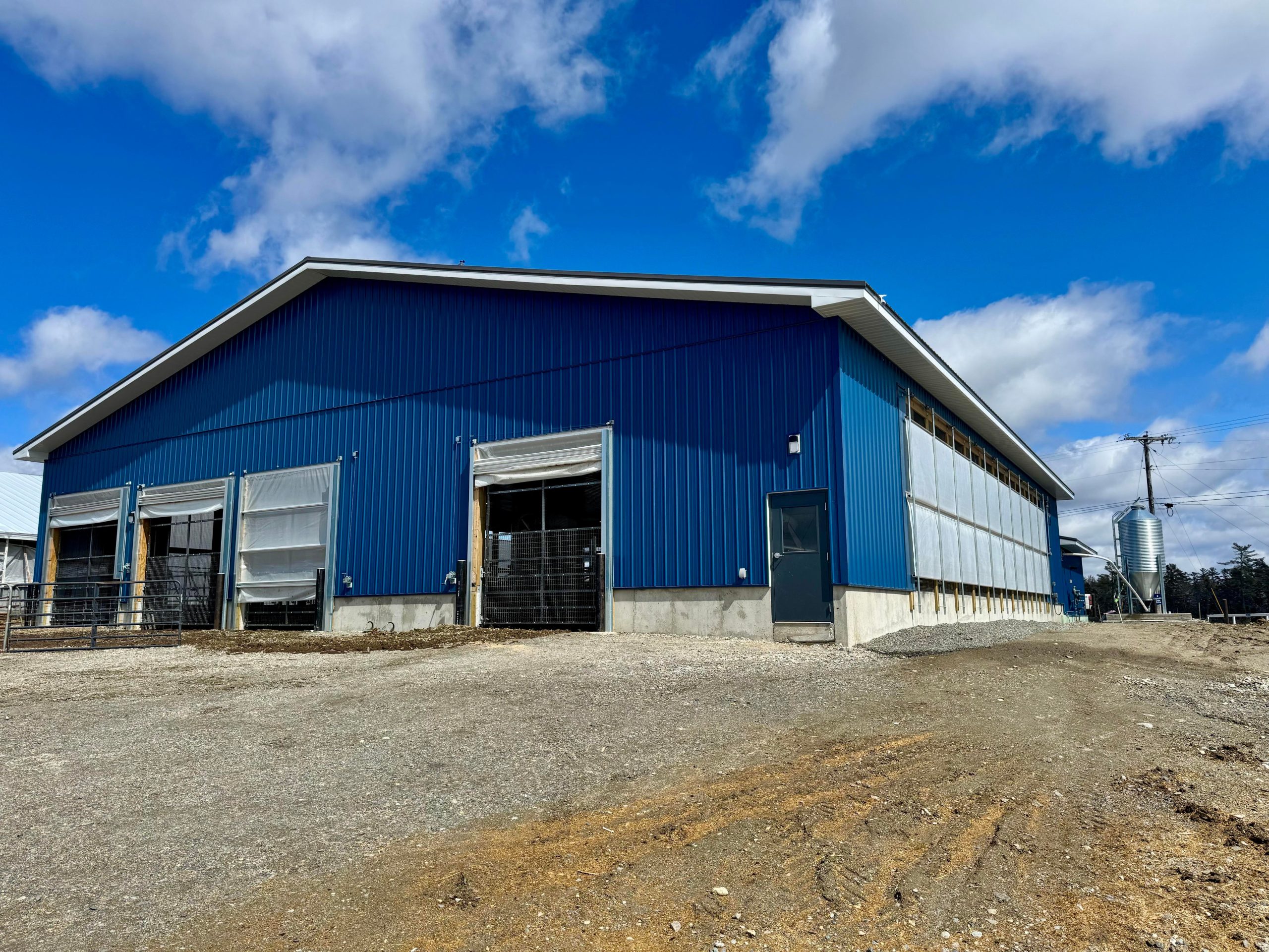 Exterior of big blue-sided buildng.