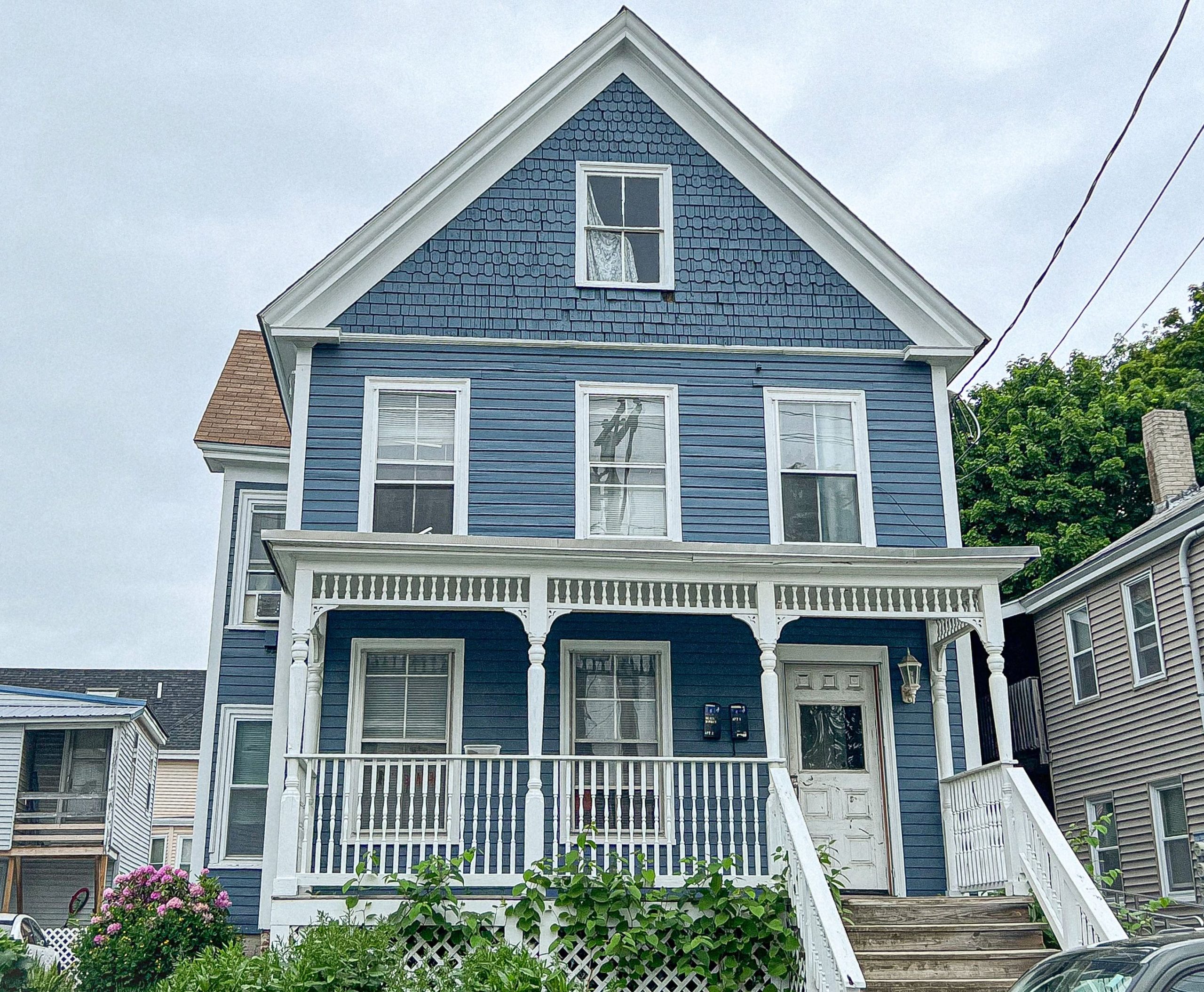 blue house with porch and railing