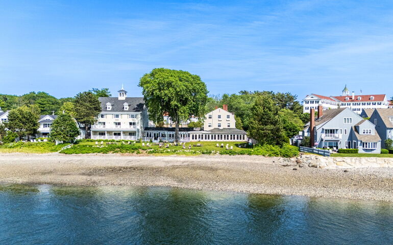 An aerial view shows buildings near a beach.