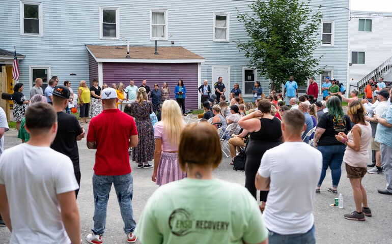 People gather outside a building.