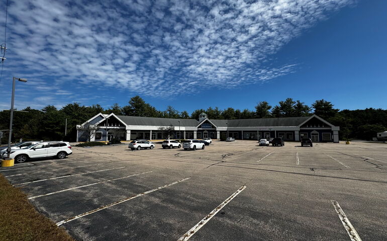 A shopping center with parking lot.
