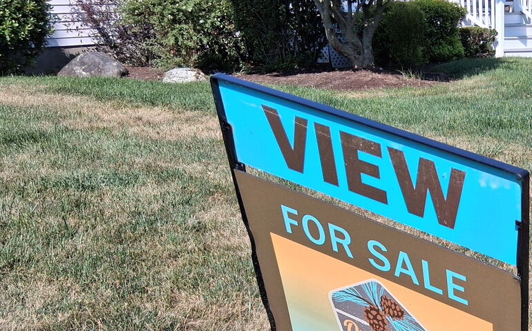 A sign with words on on a lawn.