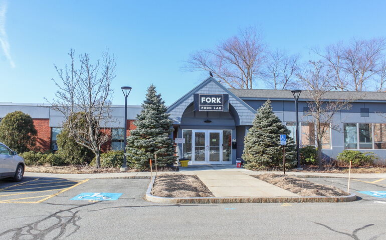 building with sidewalk and parking lot