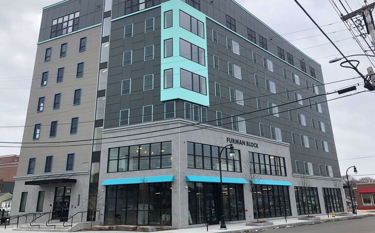 A new building has turquoise components.