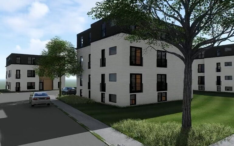 rendering of 3 modern apartment buildings, each 3 stories tall, with white sides, black top stories, and landscaping