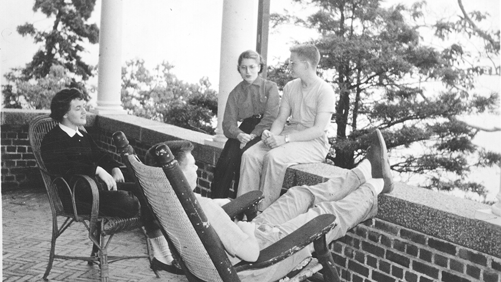 An vintage black-and-white photo shows people relaxing.