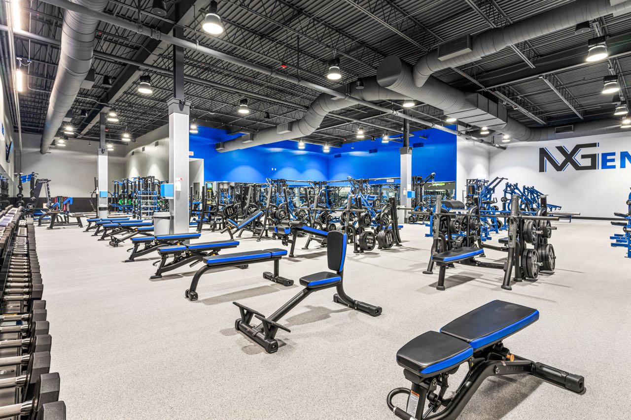 A gym room is full of exercise equipment.