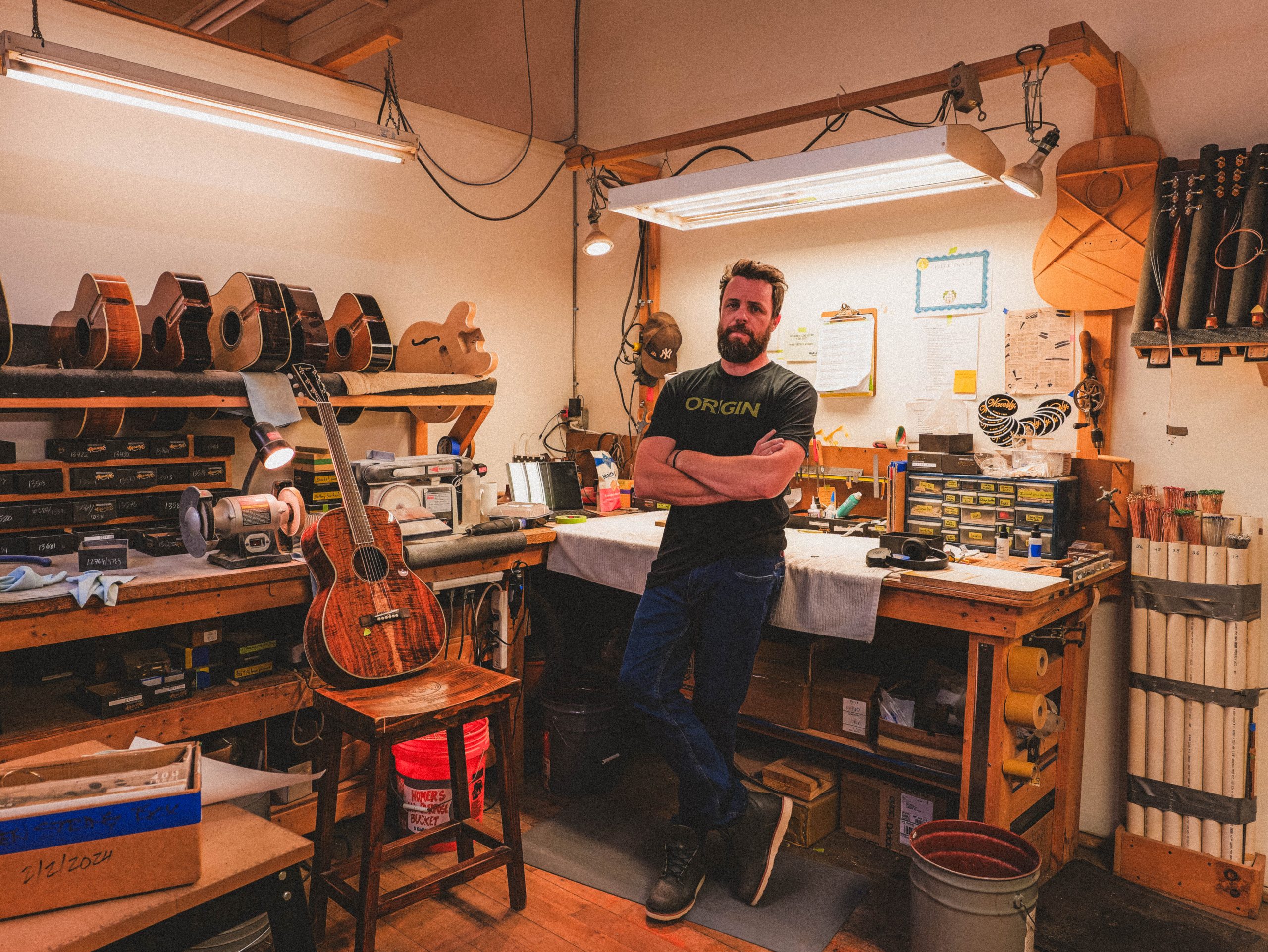 A Bourgeois employee stands in a guitar-making workshop.