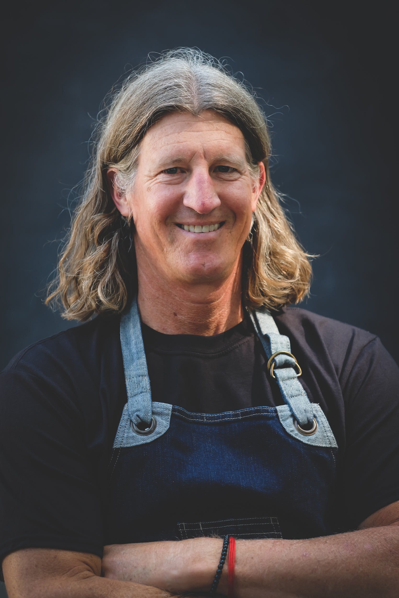 person with apron smiling