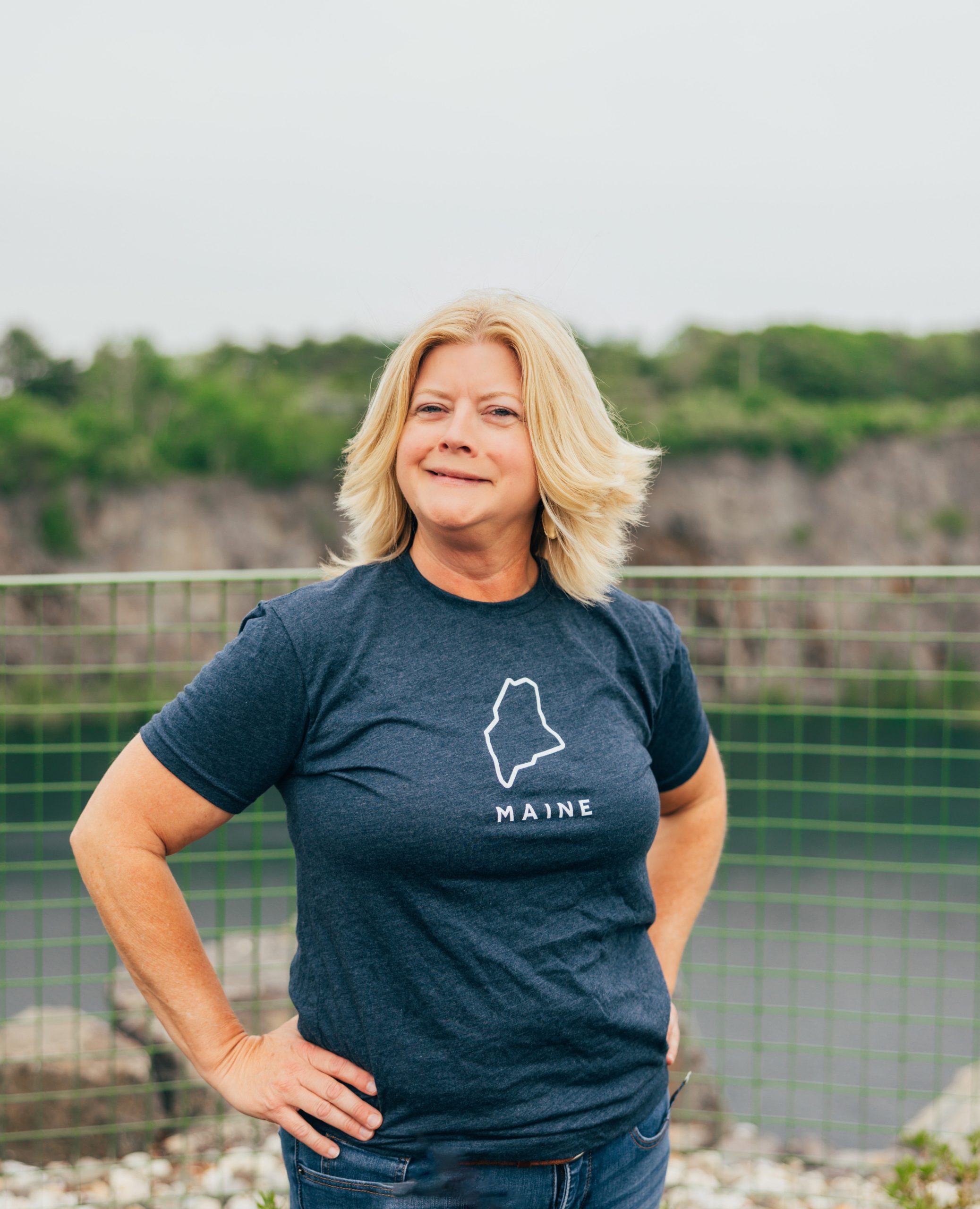 Lynda Adams in a clue shirt with blonde hair.