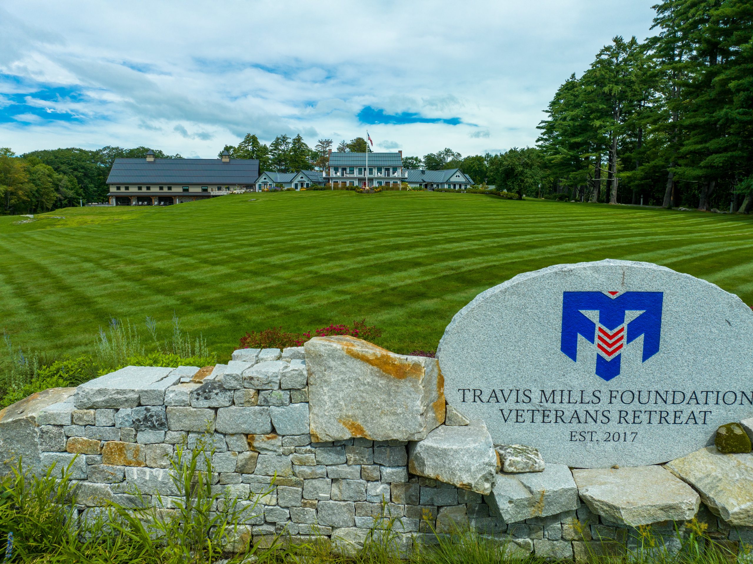 buildings in background with lawn and sign in foreground