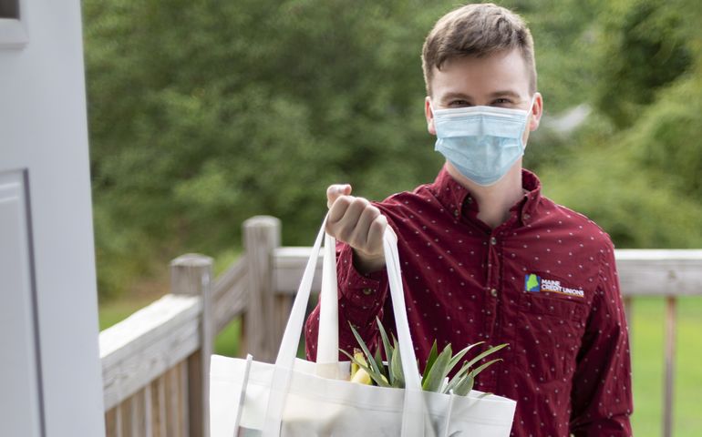 photo of volunteer holding bag with food
