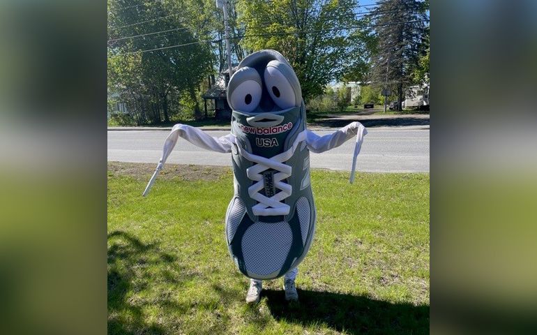 Photo of a smiling sneaker mascot