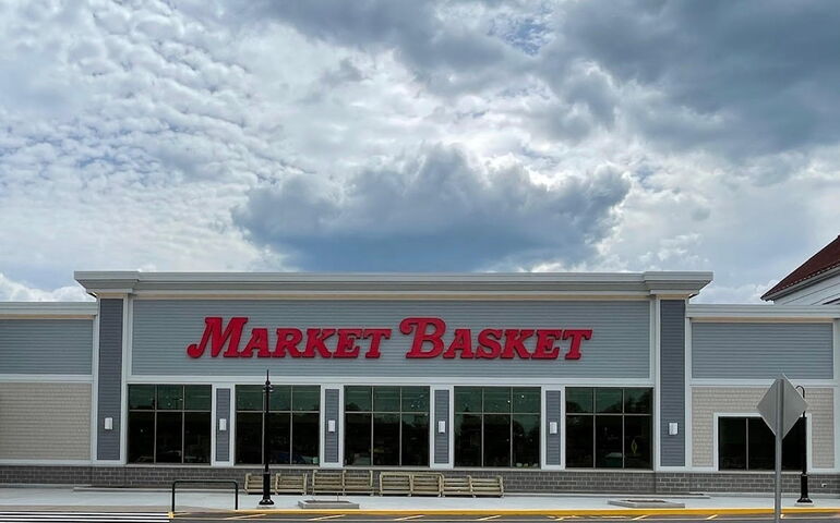 A gray and white building with the Market Basket letters in red.