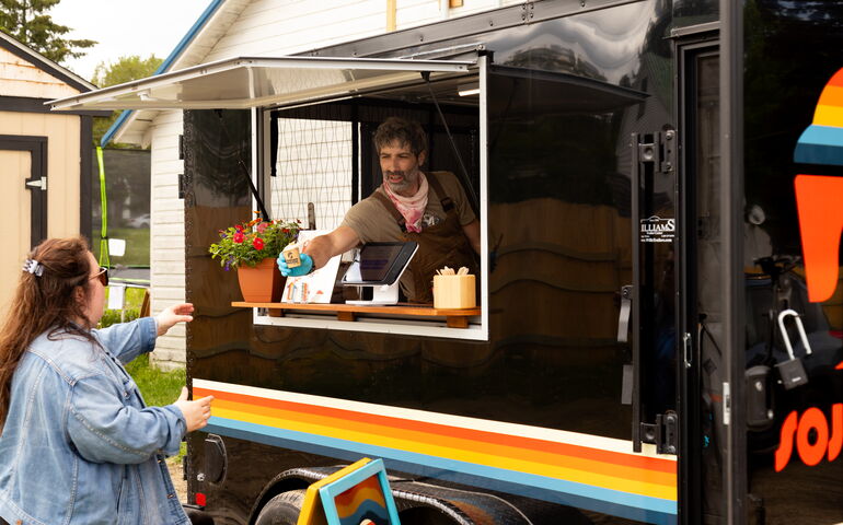 Man serving outside food truck