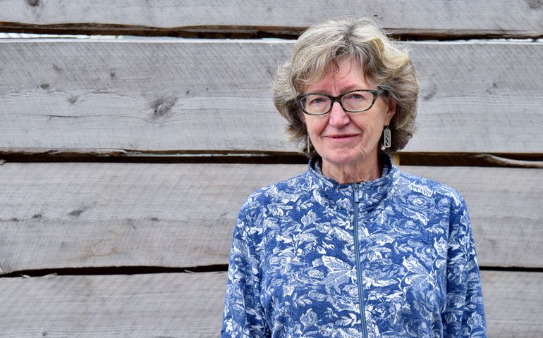 Portrait of Nan Heald from the waist up, smiling.
