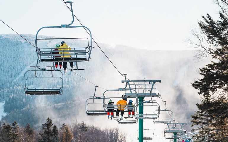people on ski lifts at Saddleback Mountain