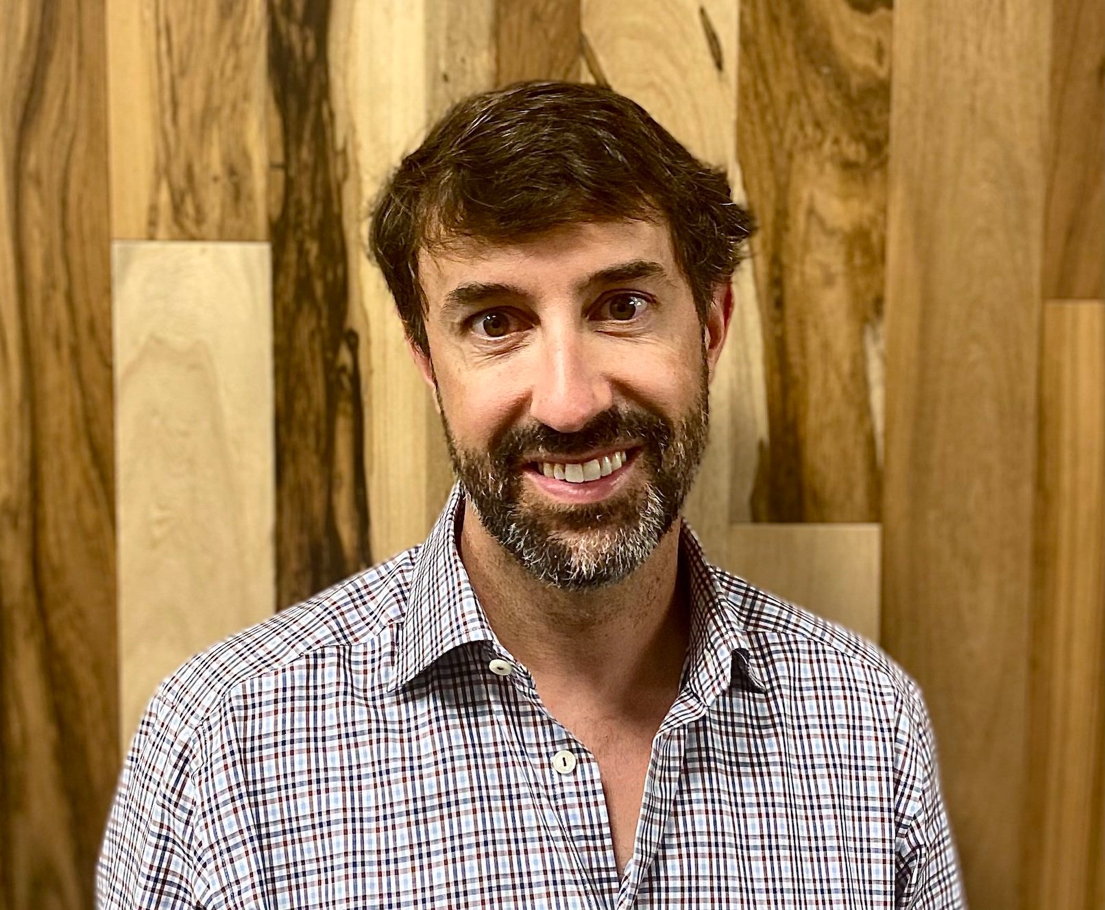 person in plaid shirt smiling