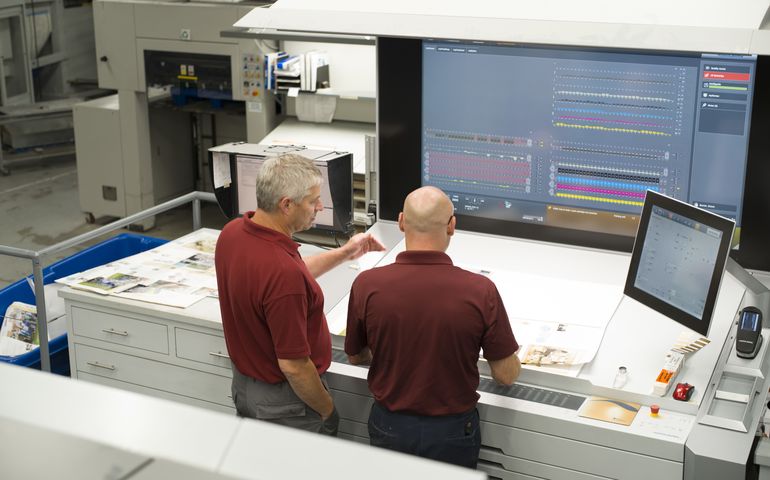 J.S. McCarthy Printers' press room manager and press operator, at a machine.