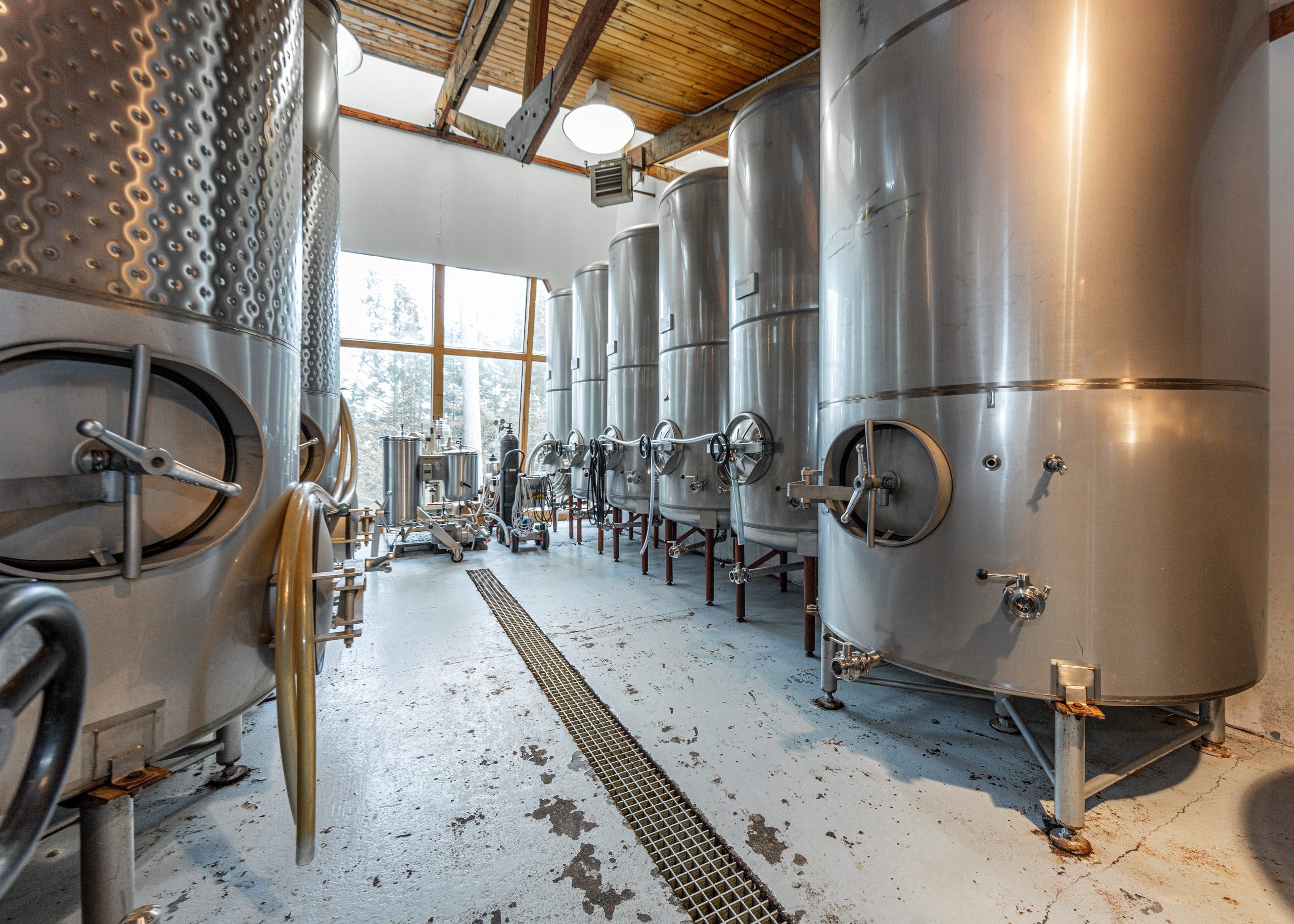 A room has rows of large tanks.