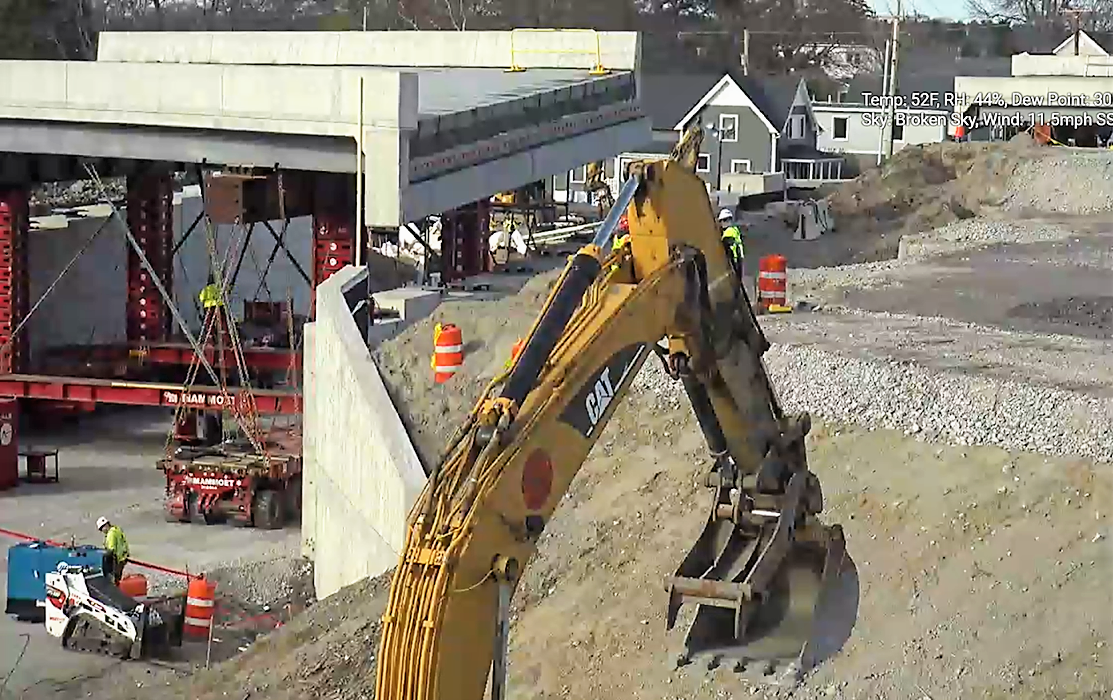 bridge section near two abutments, with yellow crane arm in foreground