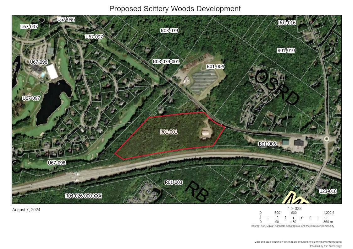 An aerial view shows woods and structures annotated.