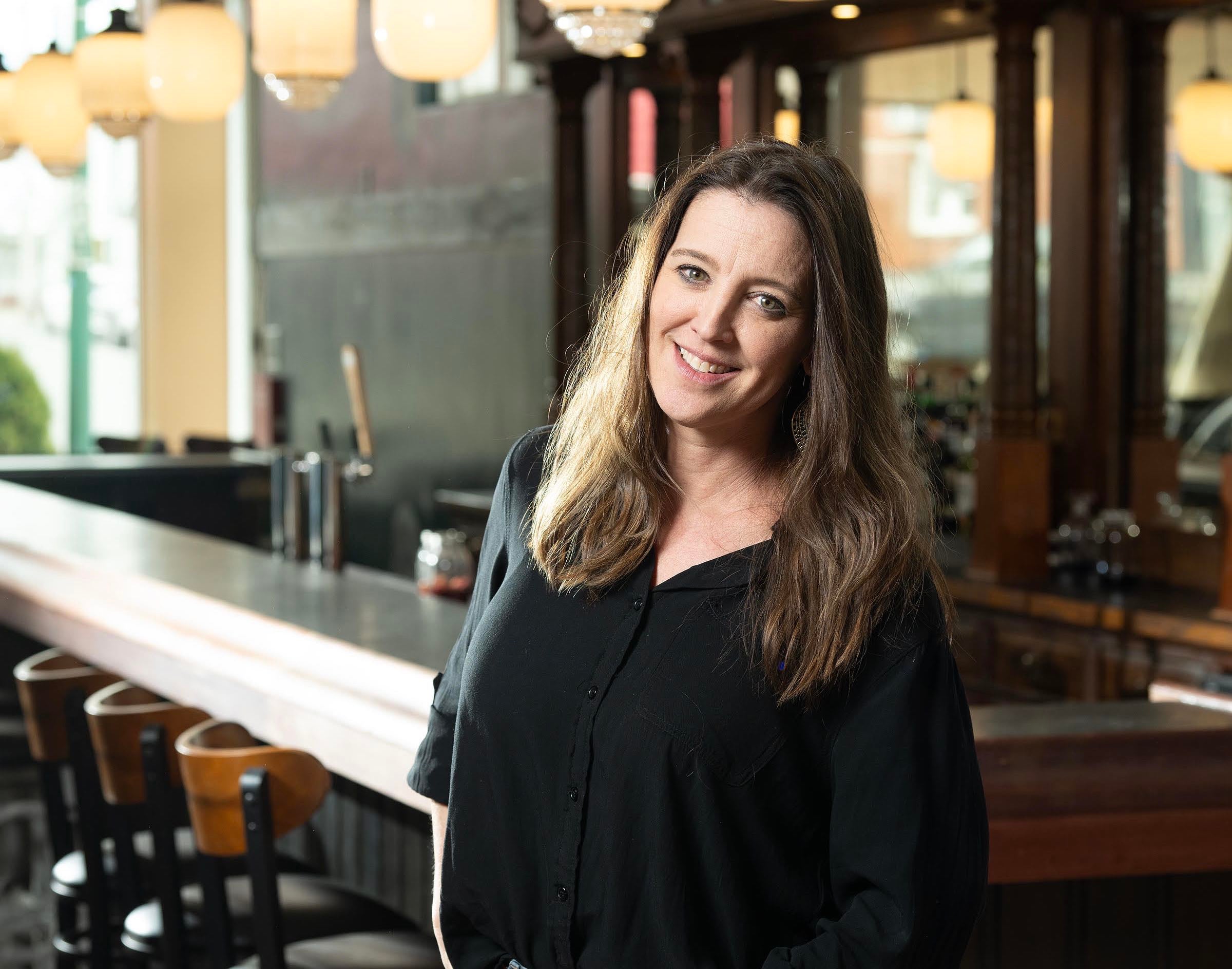 The Black Moon owner stands by the bar.
