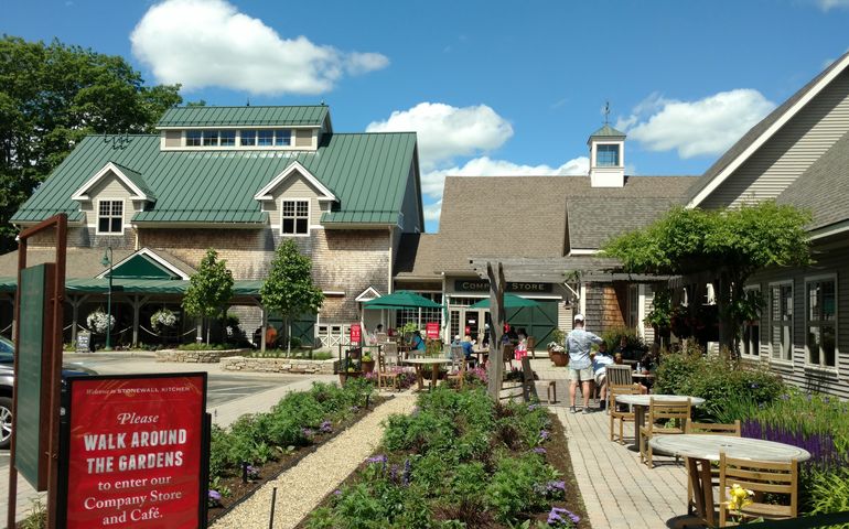 three wood-shingled buildings and garden courtyard