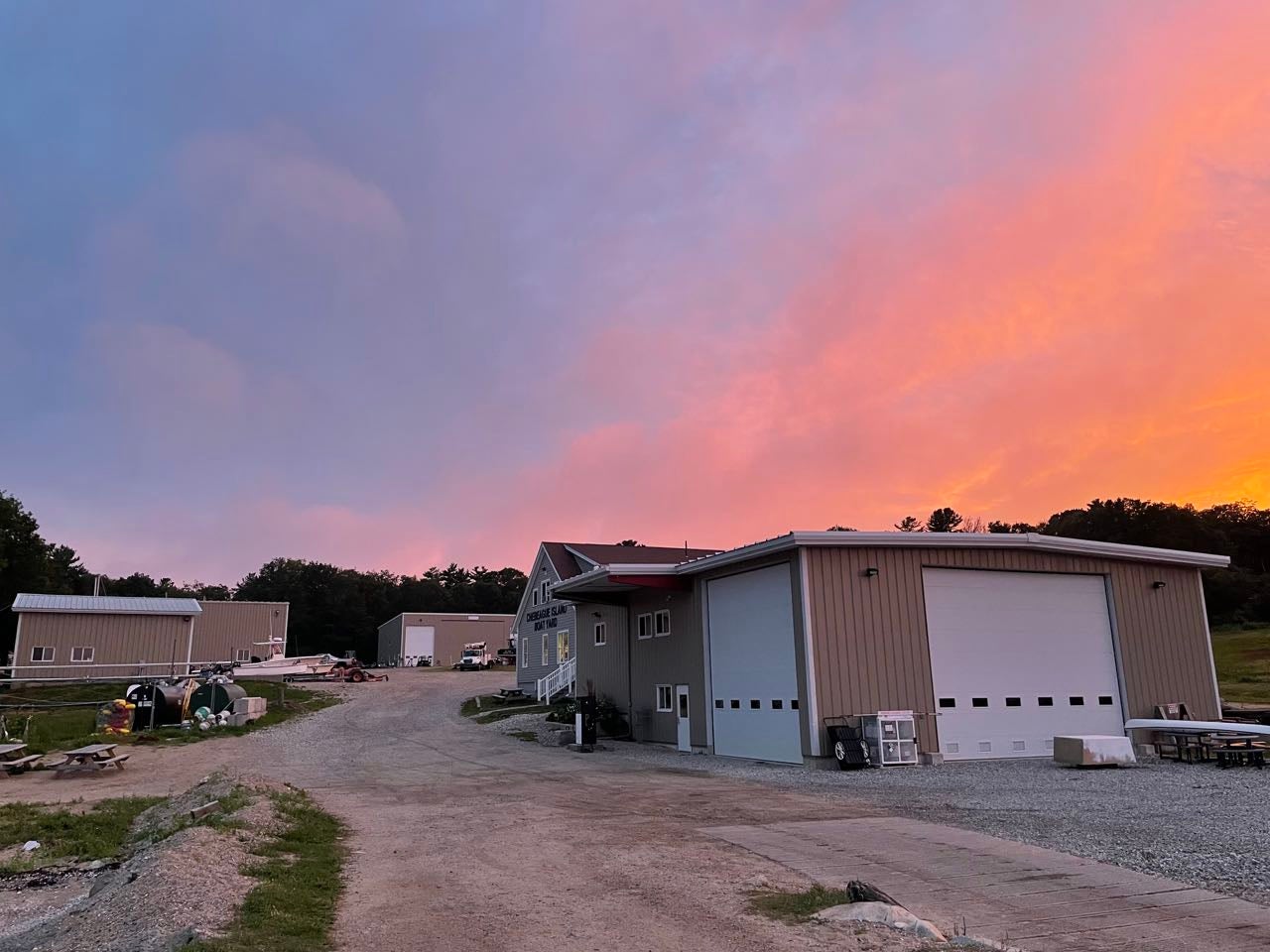 A sunset sky is over some buildings.