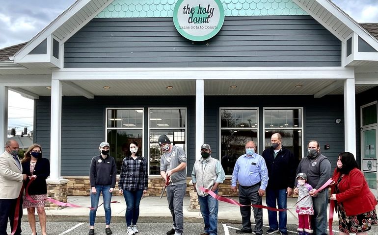 people standing in front of gray building